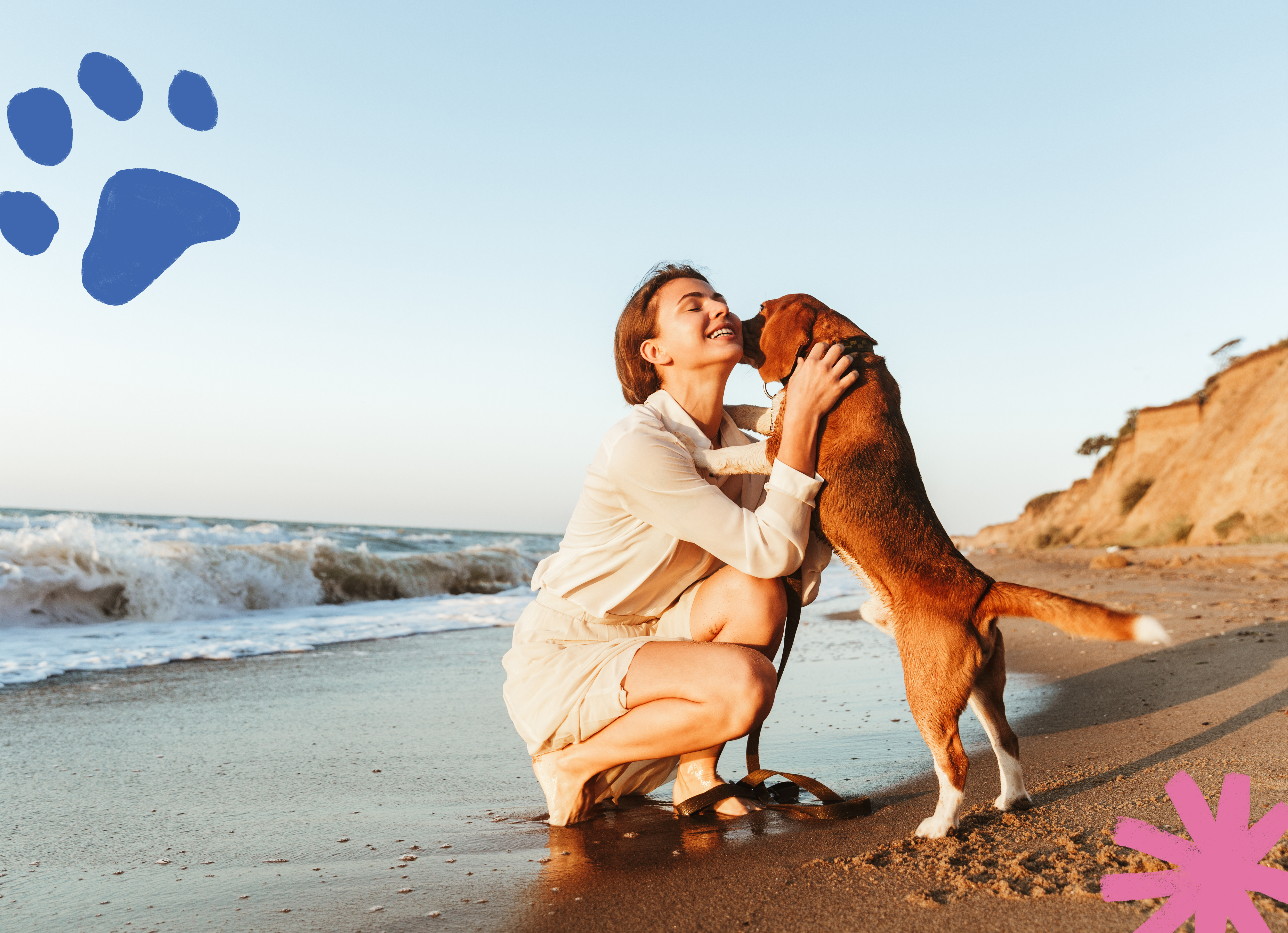 Young woman kneeling on a beach with a dog standing on its hind legs and its paws in her arms as if hugging her